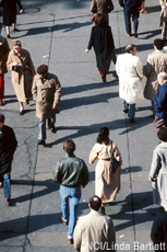 Photograph of several people walking outdoors