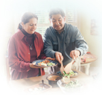 Eat healthier. A photo of a couple preparing a salad