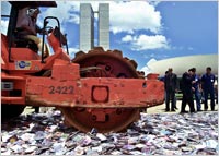 A soil compressor destroys counterfeit CDs