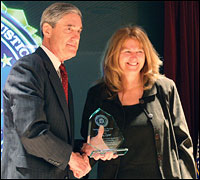 Phtograph: Director Mueller presents Patsy Spier with the 'Strength of the Human Spirit Award' for her resilience following a 2002 attack that killed her husband