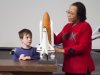 Lecturer and student look at space shuttle model.