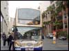 [Photo: People boarding bus for housing tour]