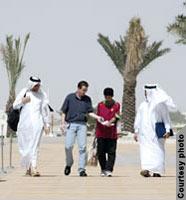 Students walk by some palm trees (Courtesy of Carnegie Mellon University-Qatar)