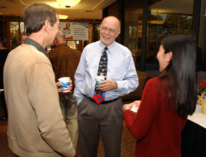Dav Robertson, left, and Melissa Chan chatted with Bill Suk.