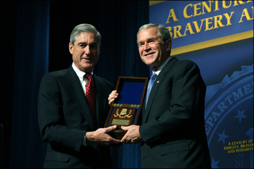 Director Mueller presents President Bush with an Honorary Special Agent award