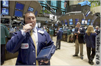 Stock trader on phone on floor of New York Stock Exchange (AP Images)