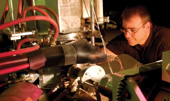 Don Brown, instrument scientist for the Spectrometer for Materials Research at Temperature and Stress, makes final adjustments before the beam is available to the Lujan Neutron Scattering Center. Photo by Robb Kramer