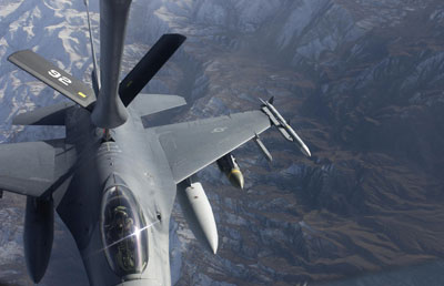 An F-16 Fighting Falcon from the 174th Fighter Wing, Syracuse, New York, receives fuel from a KC-135 from the 192nd Air Refueling Wing, Fairchild Air Force Base, over Afghanistan while supporting Operation Enduring Freedom, Nov. 29 ,2003. The 174th Air National Guard wing has both a federal and state mission. The federal mission is to provide combat ready personnel, aircraft, and equipment for worldwide deployment and the state mission is to support civil authorities at the direction of the New York State Governor in times of crisis. (U.S. Air Force photo by Staff Sgt. Suzanne M. Jenkins) (Released) Photo by: SSGT SUZANNE M. JENKINS, CHARLESTON AFB, SC Record ID No. (VIRIN): 031129-F-9629J-013