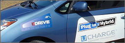 Photo of front driver's side view of a plug-in hybrid electric vehicle with decals.