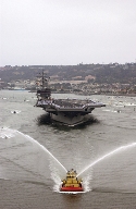The nuclear-powered aircraft carrier, USS RONALD REAGAN (CVN 76), being welcomed for the first time in her new homepost, San Diego, California.