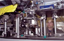 Experimental physicist Bernie Kozioziemski of NNSA’s Lawrence Livermore National Laboratory prepares a cryogenic refrigeration system used to study the deuterium-tritium fuel layer formed inside the National Ignition Facility target capsule.