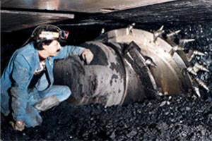Miner inspecting a Longwall Shearer
