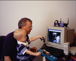 Ken Nixon and his grandson use videoconferencing technology to talk with Ken’s mother, Louise, at home in Lavaca, Arkansas. 