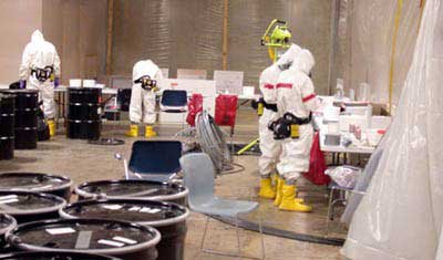 Photograph of Hazmat team in protective suits.