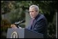 President George W. Bush responds to a question during Tuesday's news conference in the Rose Garden of the White House.  White House photo by Eric Draper