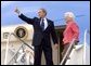 Before departing Pensacola en route Orlando, Fla., President George W. Bush gives a thumbs up sign while boarding Air Force One with his mother Barbara Bush Friday, March 18, 2005.  White House photo by Eric Draper