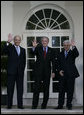 President George W. Bush is flanked by Prime Minister Ehud Olmert, left, of Israel, and President Mahmoud Abbas of the Palestinian Authority, as they wave for the cameras Wednesday, Nov. 28, 2007, after a statement in the Rose Garden regarding the Annapolis Conference.  White House photo by Eric Draper