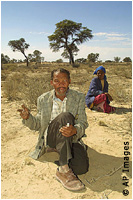 two people sitting in desert (AP Images)