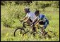 President George W. Bush and 2005 Tour de France winner Lance Armstrong take a ride together through a field of sunflowers on the President's ranch in Crawford, Texas on August 20, 2005.  White House photo by Paul Morse