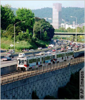Light rail train on bridge (AP Images)