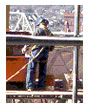 Worker standing on a make-shift scaffold