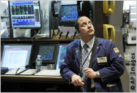 Stock trader watches monitors (AP Images)