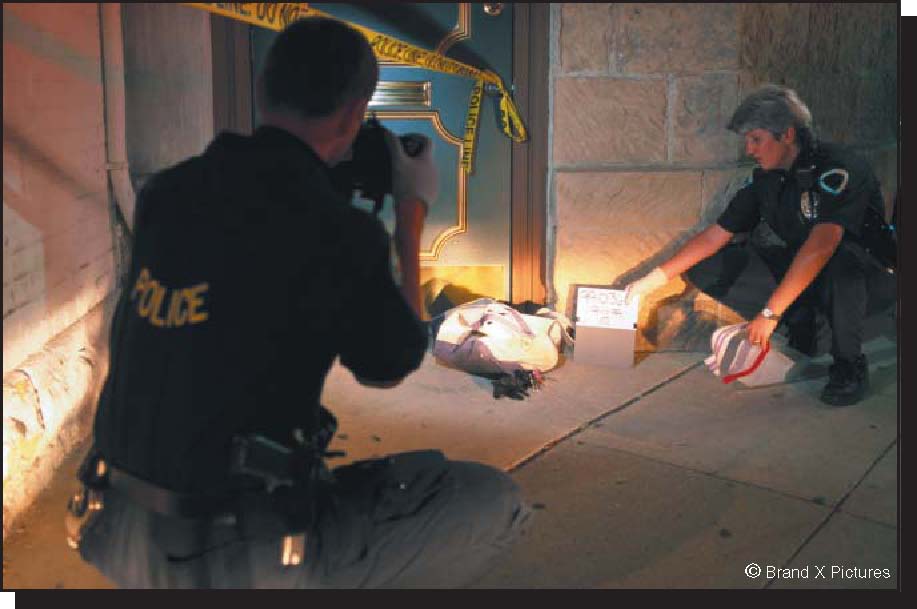 Photograph of police officer photographing evidence at a crime scene