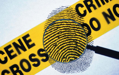 Crime scene tape, a fingerprint and a magnifying glass