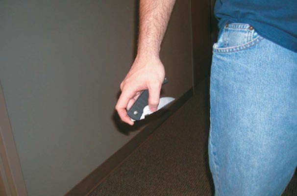 Photograph of man holding a pocket knife by his side