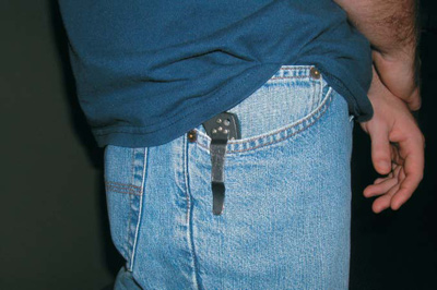 Photograph of man with knife in his jeans pocket