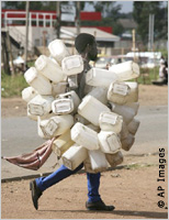 Man carrying bunches of plastic containers (AP Images)