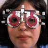 A patient wears a trial frame and lenses.