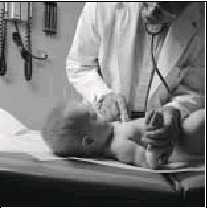 Photograph of a doctor examing a baby