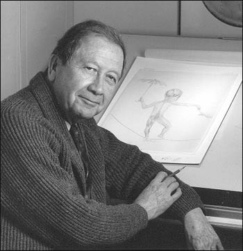 Photograph of Howard Bartner in front of a drawing table