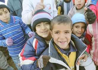 Children smile for the camera in the village of Atshiyana, Iraq, Jan. 12, 2009. The children of the community were invited to a school opening in Kirkuk province.  Photo by Petty Officer 2nd Class Brian L. Short, 11th Public Affairs Detachment.