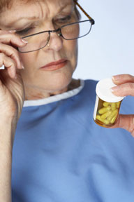 Woman reading prescription bottle