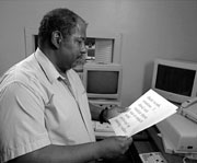 Ernest Stribling reading a large-print page.