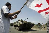 A protestor waves a Georgian flag