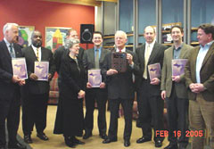 All seven project award recipients stand with FOD Louis M. Berra (center, holding plaque) as part of their induction into the Grand Rapids Field Office's "2004 Wall of Fame."