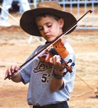 Cameron Faryadi
            was a participant in this year's Old Time Fiddlers' Convention, which attracted about 40,000 people to each performance. Photo
            by Brian Funk, The Galax Gazette.