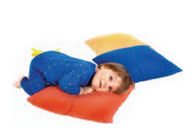 Toddler resting on a floor pillow.