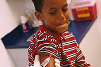 A young boy receiving a vaccination.