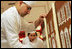 Thaddeus DuBois, Head Pastry Chef, places columns of white chocolate onto of the official White House gingerbread house.