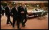 After meeting with European Union leaders, President George W. Bush walks with EU President Jean-Claude Juncker at Justus Lipsius in Brussels.