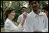 Mrs. Laura Bush signs the team jerseys of the Islamabad College of Boys cricket team, who participated in a cricket clinic with President George W. Bush, Saturday, March 4, 2006 at the Raphel Memorial Gardens on the grounds of the U.S. Embassy in Islamabad, Pakistan.