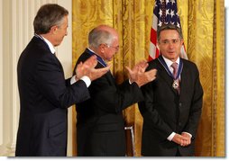 Colombian President Alvaro Uribe is congratulated by former Prime Minister John Howard of Australia, and former Prime Minister Tony Blair, left, of the United Kingdom after he was honored by President George W. Bush with the 2009 Presidential Medal of Freedom during ceremonies honoring all three leaders with America's highest civil award. White House photo by Joyce N. Boghosian