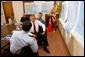 President George W. Bush is briefed by Under Secretary for Emergency Preparedness and Response, Mike Brown, on Tropical Storm Bonnie and Hurricane Charley at the City of Miami Fire House Number Two in Miami, Fla. Also present at the briefing were (from left) Laura Bush, Congressman Bill Young and Governor Jeb Bush, Friday, August 27, 2004.  White House photo by Tina Hager