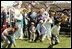 President Reagan and First Lady Nancy Reagan watch as children roll eggs at the 1982 White House Easter Egg Roll. 