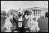 Children dressed in bunny ears pose at the 1958 Easter Egg Roll on the South Lawn. 