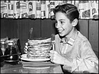 Child actor Johnny Crawford prepares to eat pancakes, circa 1960.